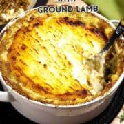 A baked Irish shepherd’s pie with a golden, textured mashed potato topping in a white dish. A spoon is serving some pie, revealing a meat and vegetable filling inside. Text reads “Irish Shepherd’s Pie with Ground Lamb.”.