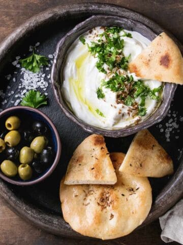 Lebanese labneh served with pita bread and olives.