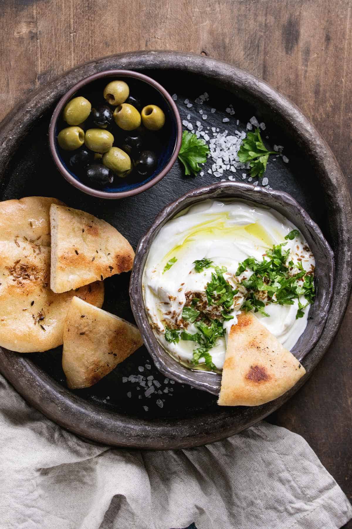 Lebanese labneh served with pita bread and olives.