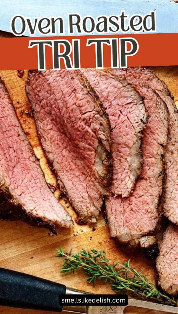 Sliced oven roasted tri-tip steak on a cutting board with a sprig of thyme, a knife visible at the top, and the text "Oven Roasted Tri Tip" above the meat.