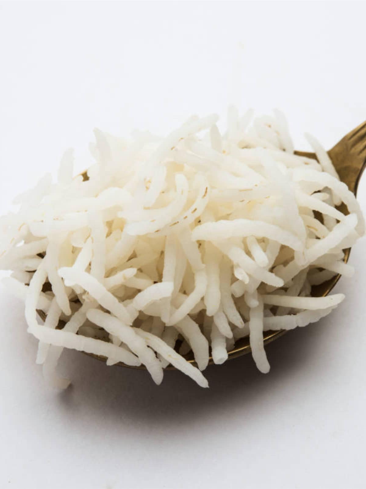Close-up of fluffy basmati rice showing long separate grains cooked in a rice cooker.