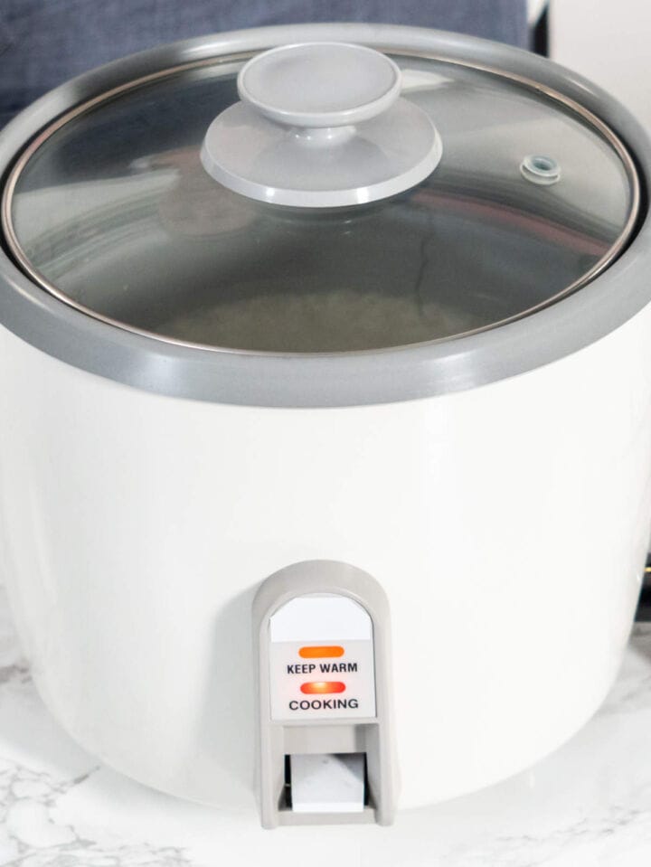 Rice cooker set to brown rice setting for cooking short grain brown rice.