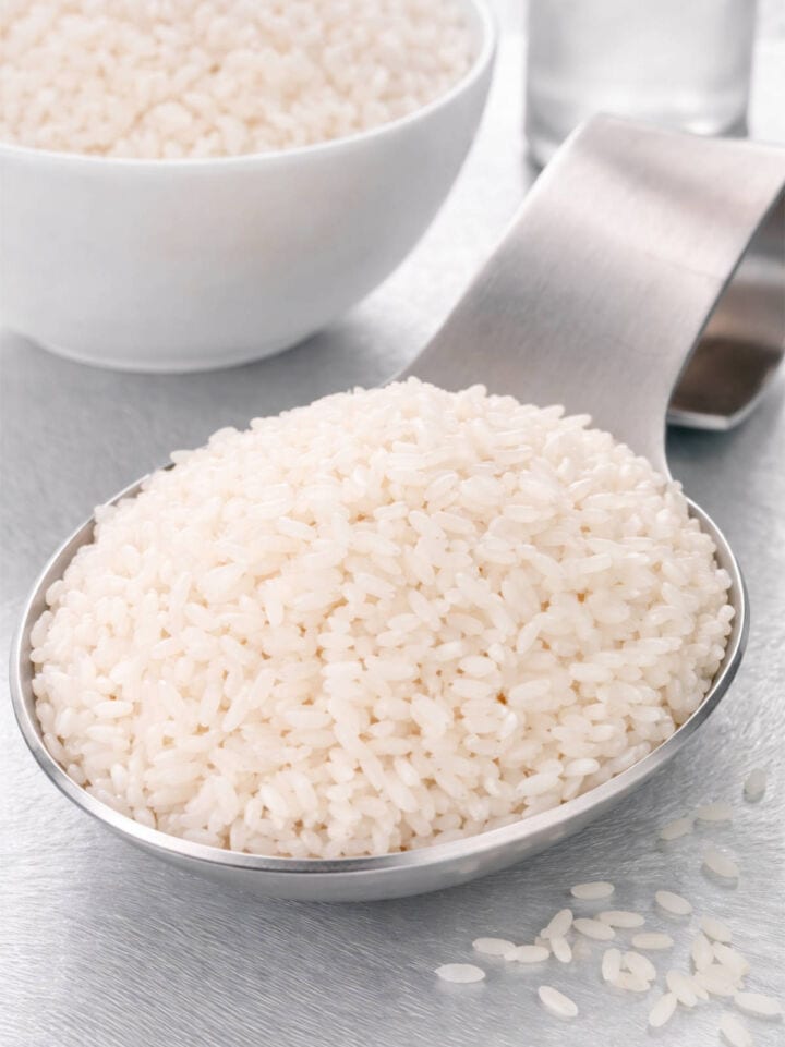 Measured cup of raw sushi rice.
