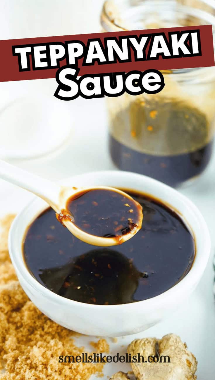 A white bowl filled with dark teppanyaki sauce, with a spoon lifting some sauce. Behind it is a jar of sauce and ingredients on a white surface. Text reads