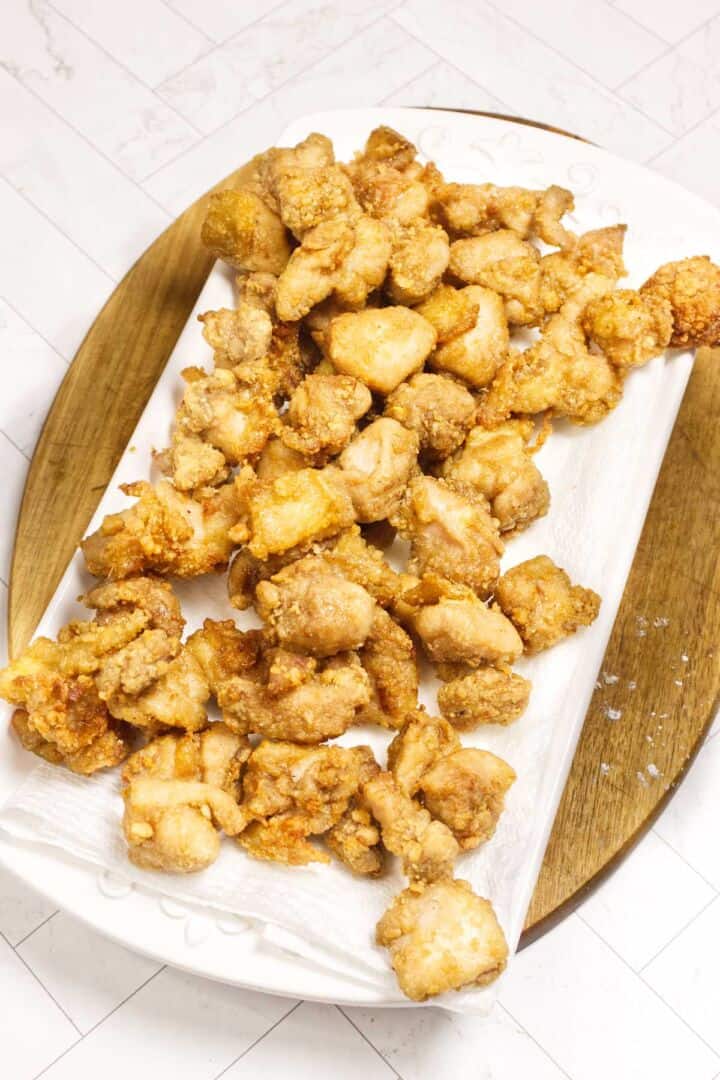 First-fried karaage resting on a platter before the second fry.