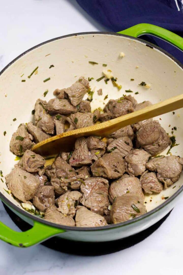 Lamb browning in a Dutch oven for stew.
