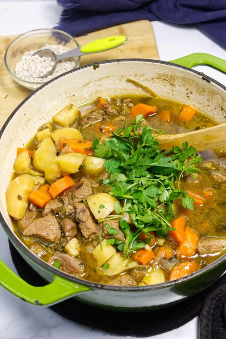 Finished Irish lamb stew with herbs stirred in.