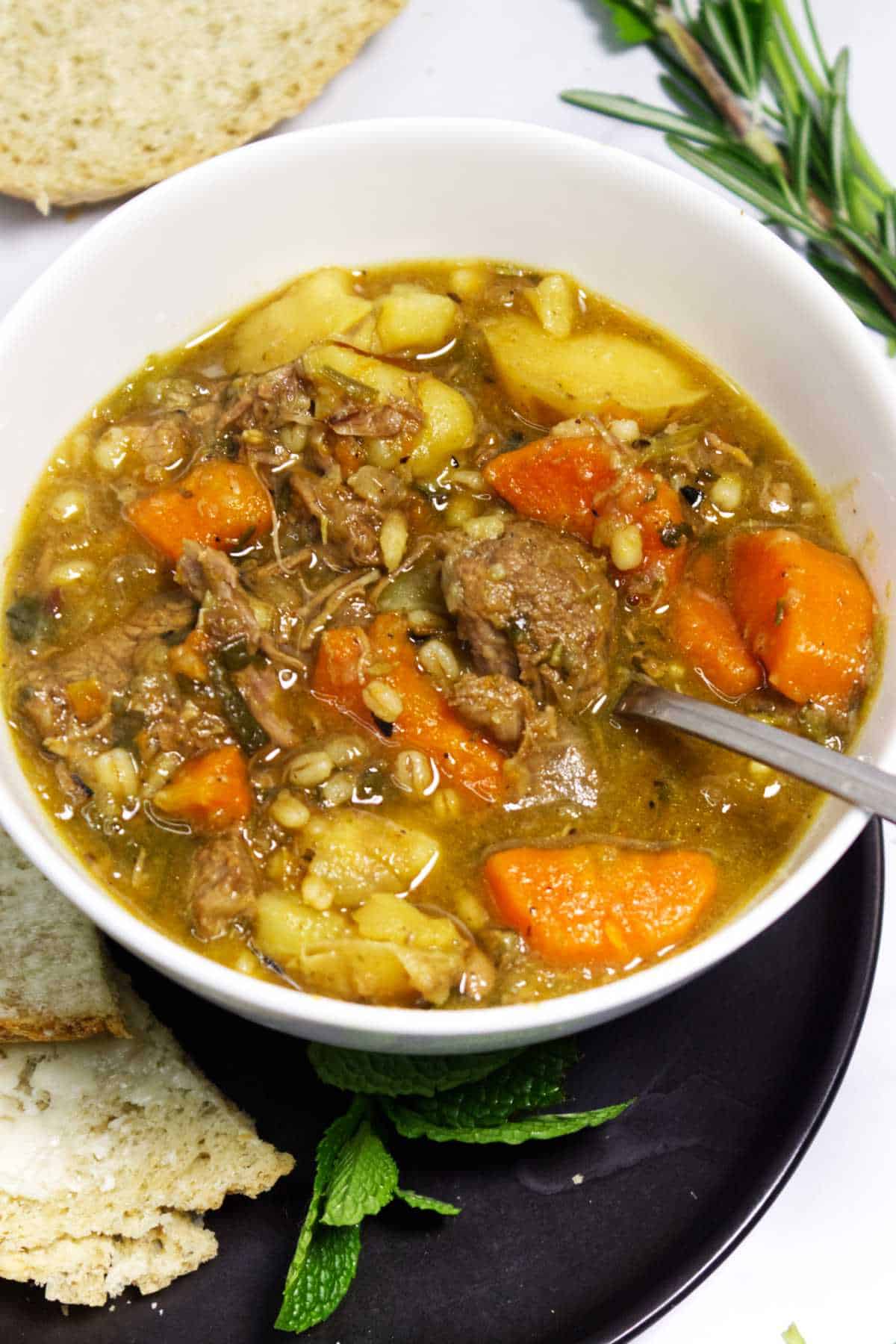 Irish lamb stew served with bread on the side.