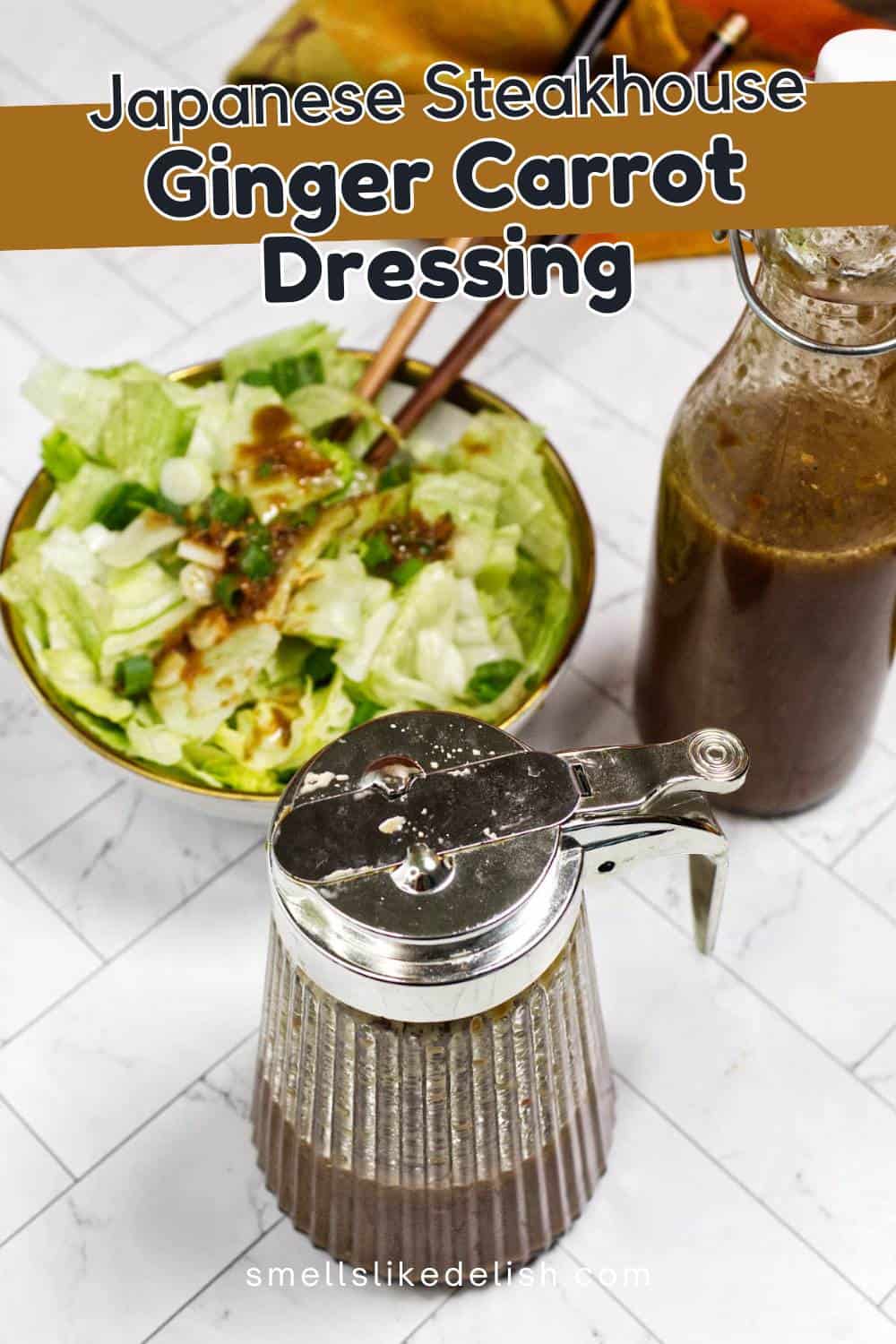 A bottle and a dispenser of brown ginger carrot dressing sit beside a salad bowl filled with lettuce and topped with dressing, on a white marble surface. Text above reads "Japanese Steakhouse Ginger Carrot Dressing.