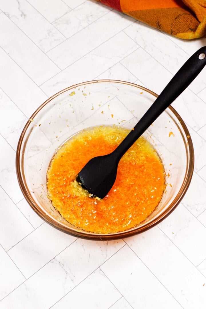Water and rice vinegar added to the grated carrot and ginger mixture for Japanese ginger dressing.