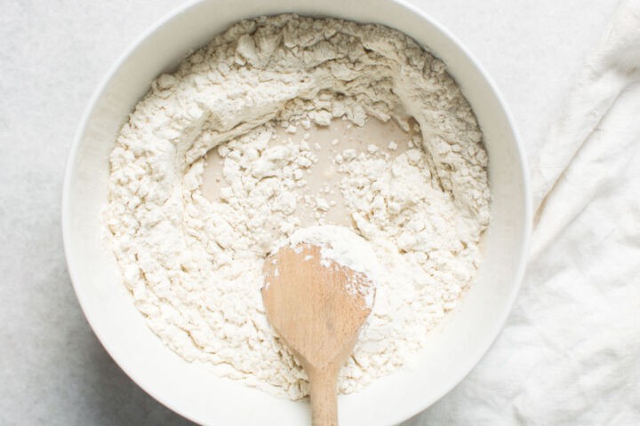 Rough dough forming in bowl for Mexican bread rolls.