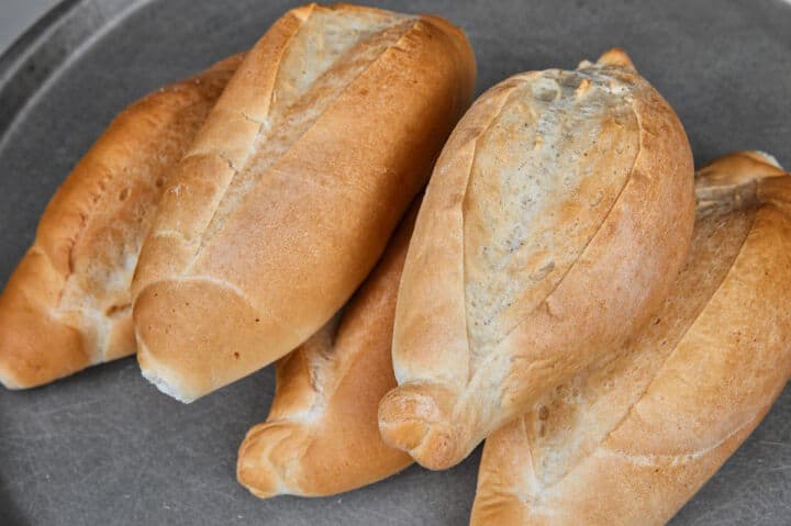 Fresh baked bolillo rolls with golden crust.
