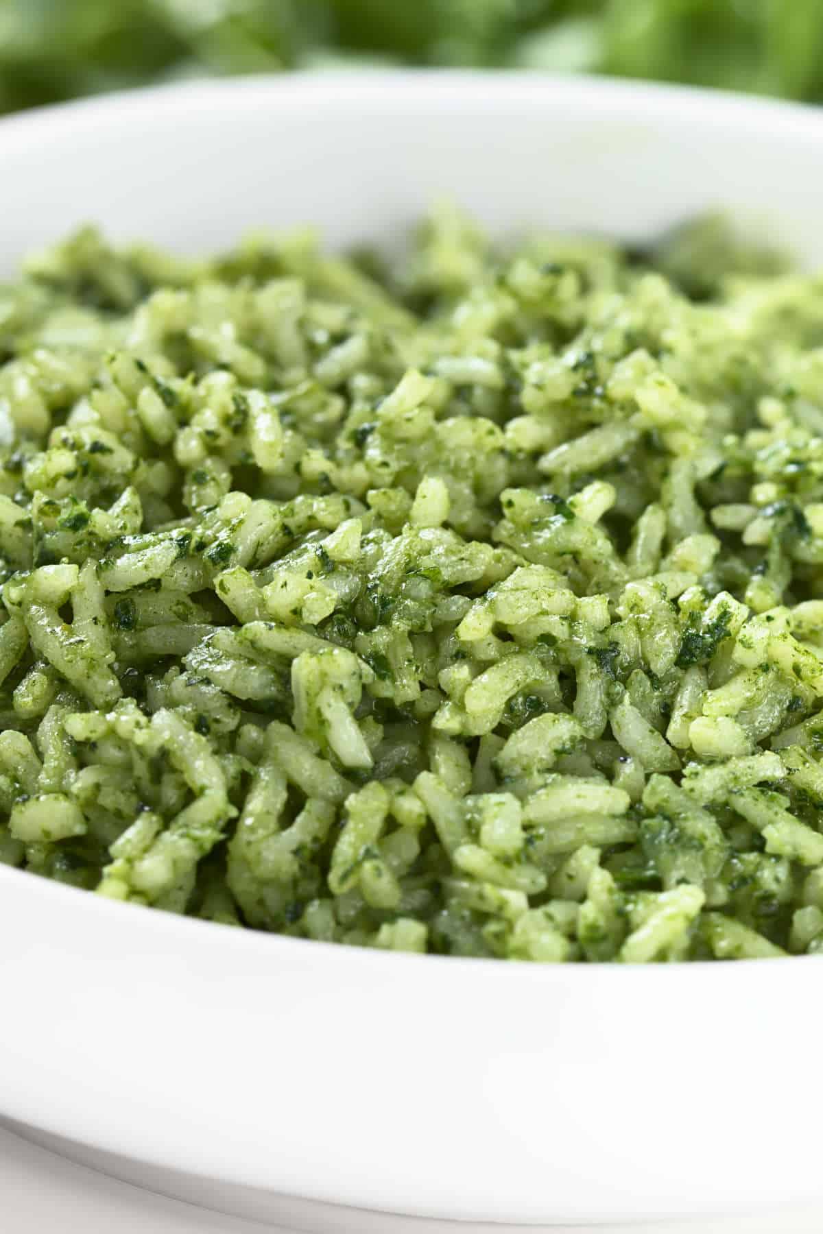 Bowl of fluffy Mexican green rice served with cilantro garnish.