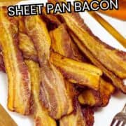 A white plate filled with crispy baked bacon strips sits on a wooden tray. Text on the image reads "How to make bacon in the oven, sheet pan bacon." A fork and an orange cloth are visible in the background.