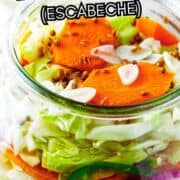 Homemade Mexican pickled vegetables with carrots, jalapenos, and red onions packed in a clear vinegar brine.