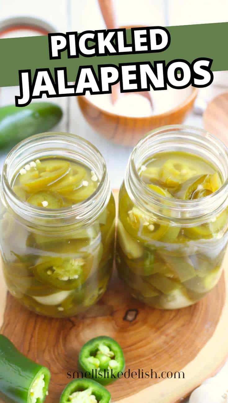 Pickled jalapenos packed in mason jars with hot brine before sealing.