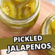 Overhead view of mason jars filled with pickled jalapenos and brine.