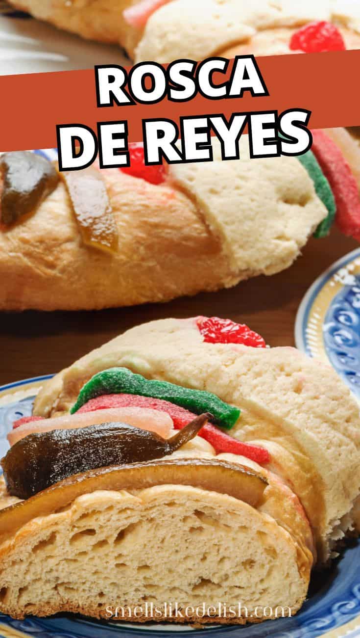 Close-up of Rosca de Reyes with candied fruit and cookie paste topping on a blue plate.