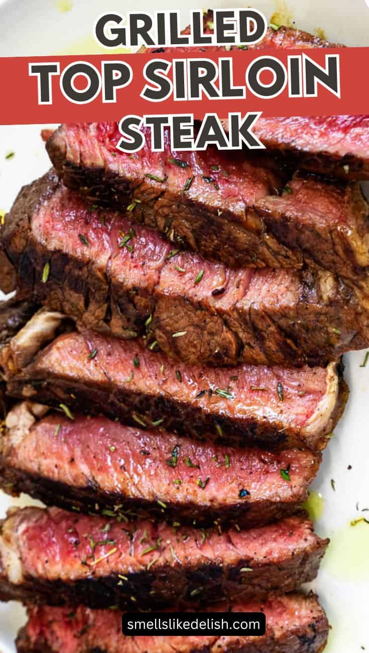Sliced grilled top sirloin steak with herbs and a pink medium-rare center.