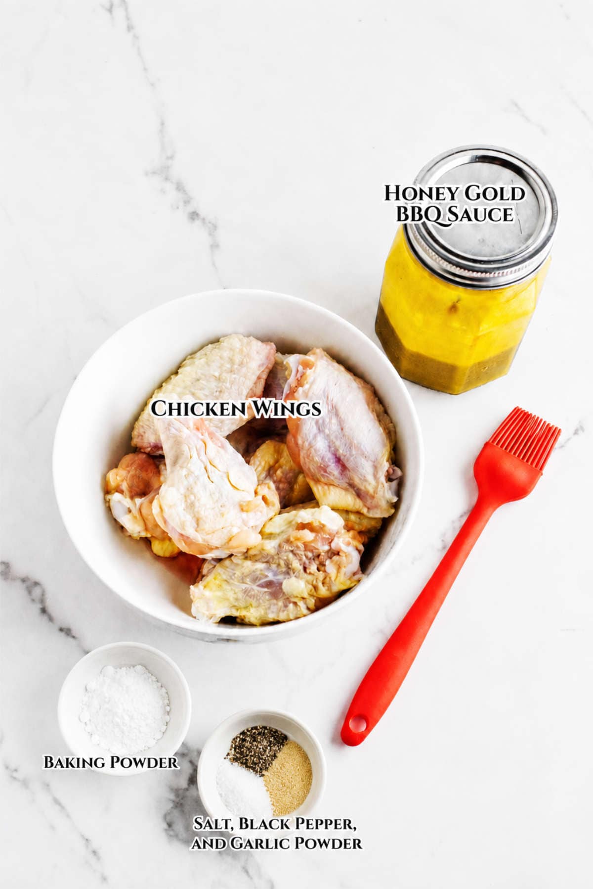 Ingredients for Honey Gold Wings with chicken wings, honey gold BBQ sauce, seasonings, and a basting brush.