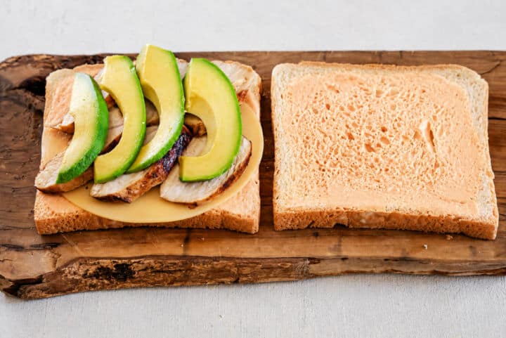 Open Panera Chipotle Chicken Avocado Melt with Gouda, chicken, avocado, sweet red peppers, cilantro, and chipotle mayo.