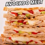 Panera chicken avocado melt sandwiches with cheese, red peppers, and avocado on a wooden board.