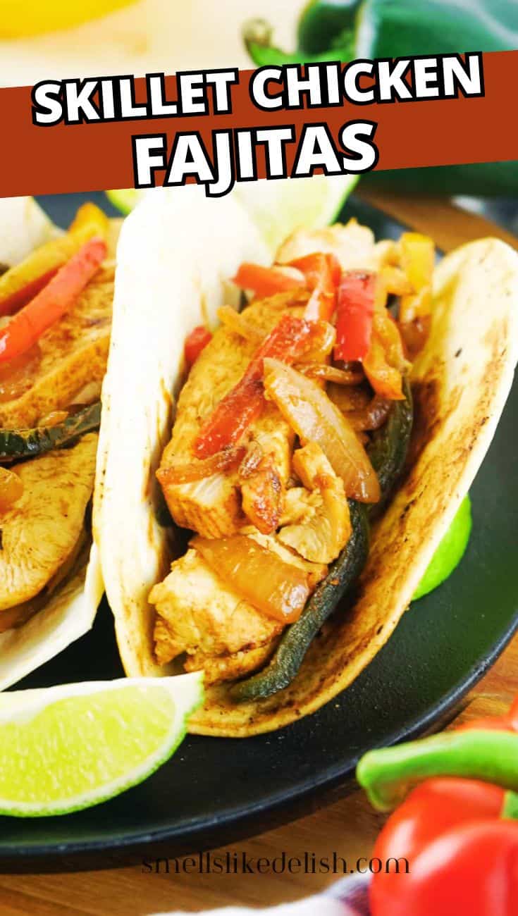 Two chicken fajita tortillas with onions, peppers, and lime wedges.