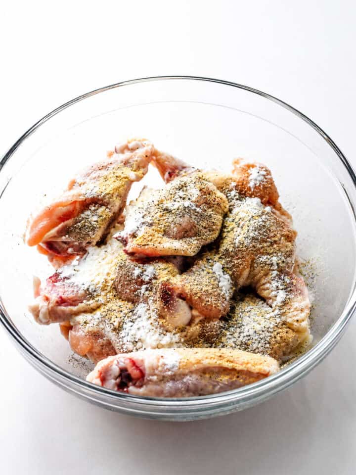 Raw chicken wings tossed with cornstarch, baking powder, garlic powder, salt, and pepper.
