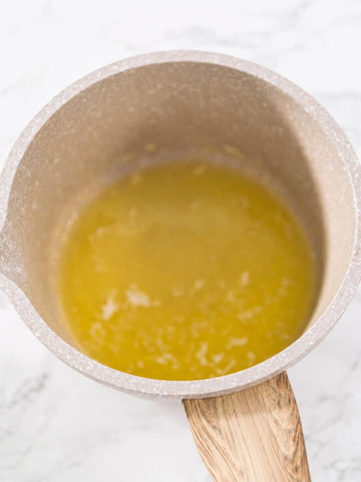 Melted butter in a small saucepan for Korean-style soy garlic glaze.