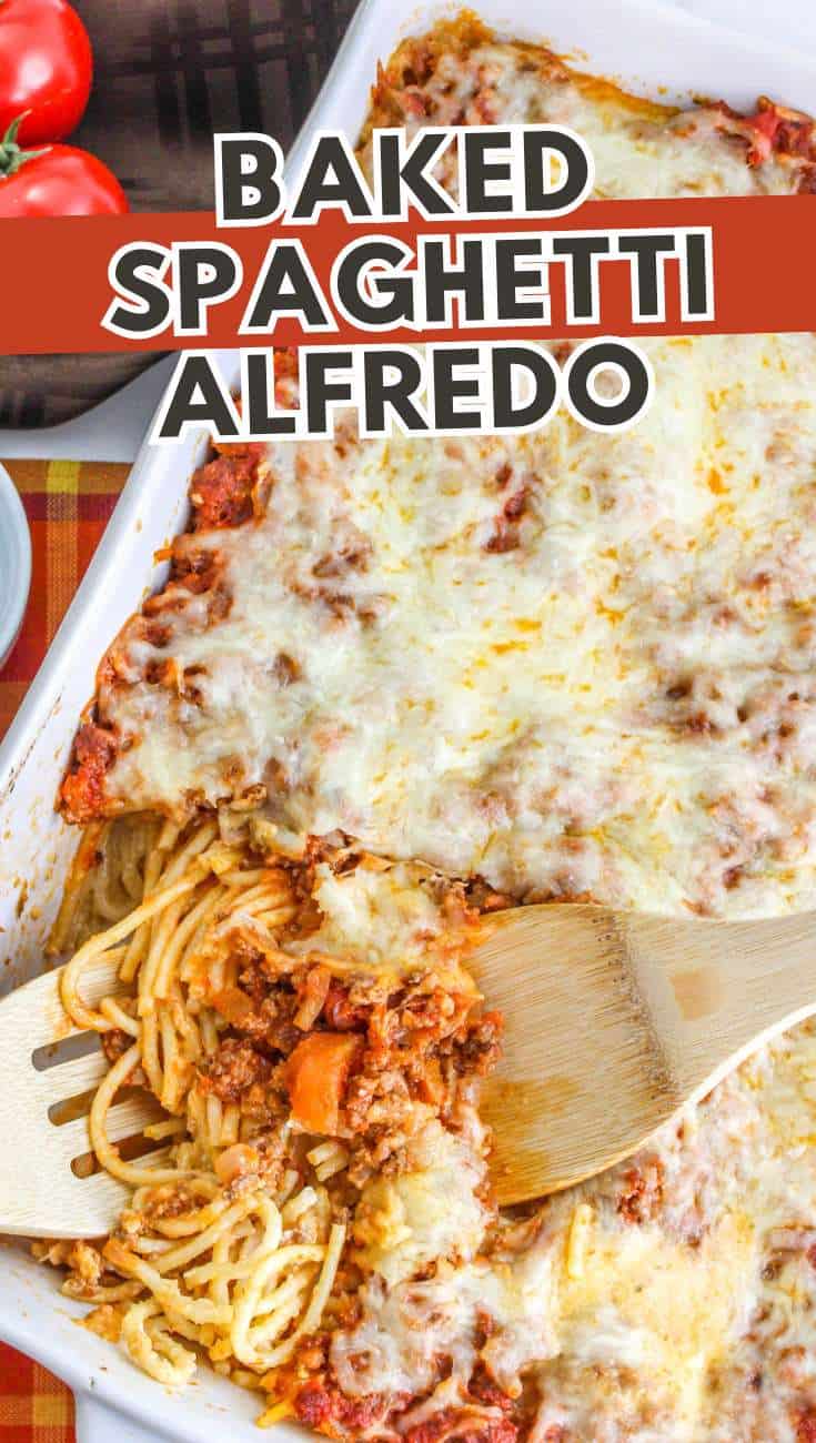 Baked spaghetti Alfredo in a casserole dish with melted cheese, a wooden spatula lifting a serving. Fresh tomatoes and a plaid napkin are beside it. Text: "Baked Spaghetti Alfredo.