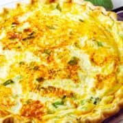 Golden-brown broccoli bacon quiche with green herbs in a pie dish; top green banner says "BROCCOLI BACON QUICHE," and "smellslikedelish.com" appears at the bottom.