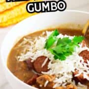 Chicken and sausage gumbo in a bowl with shredded cheese, parsley, and cornbread slices in the background. Text: "Chicken and Sausage Gumbo.