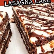 Sliced chocolate brownie lasagna cake with visible layers of brownies, white cream, and chocolate drizzle. Text says "CHOCOLATE BROWNIE LASAGNA CAKE.