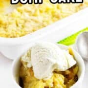 A white ramekin with peach dump cake and vanilla ice cream sits before a baking dish of the same dessert, with a spoon nearby.