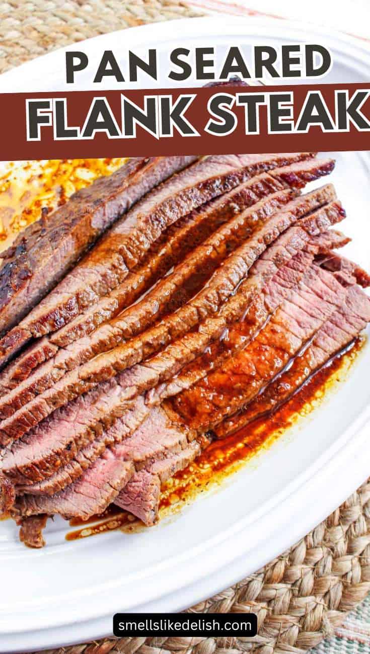 Sliced pan-seared flank steak with browned edges and red juices on a white plate atop a woven placemat.