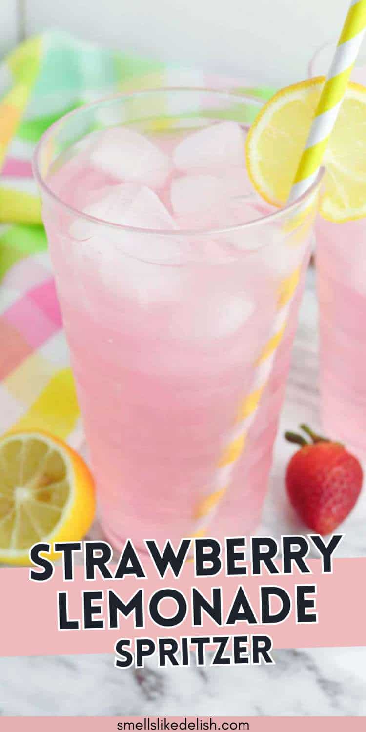 Glass of pink strawberry lemonade spritzer with ice, lemon slice, yellow striped straw, and a strawberry on a colorful cloth. Text: STRAWBERRY LEMONADE SPRITZER.