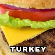 Turkey burger with lettuce, tomato, cheddar cheese, and a bun. Text: “Air Fryer Turkey Burgers.”.