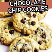 Chocolate chip cookies stacked on a white surface with “Bakery Style Chocolate Chip Cookies” text at the top.