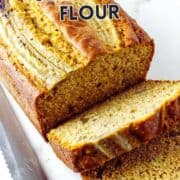 Sliced banana bread on a white surface with a bread knife. Text: “Banana Bread with Self-Rising Flour.” Website: smellslikedelish.com.