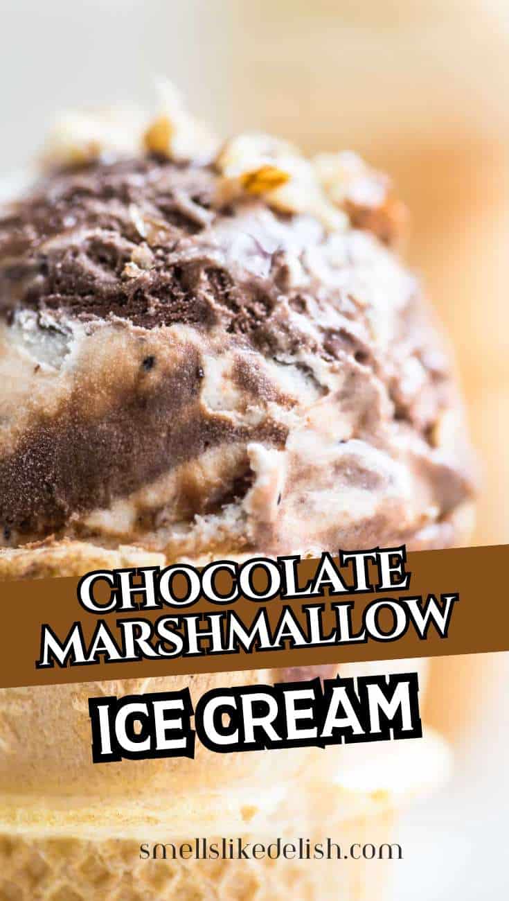 Scoop of chocolate marshmallow ice cream in a cone with visible nuts on top and