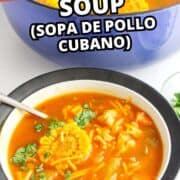 Bowl of Cuban chicken soup with corn, chicken, and cilantro beside a blue pot of soup, with text overlay: “Cuban Chicken Soup (Sopa de Pollo Cubano).”.