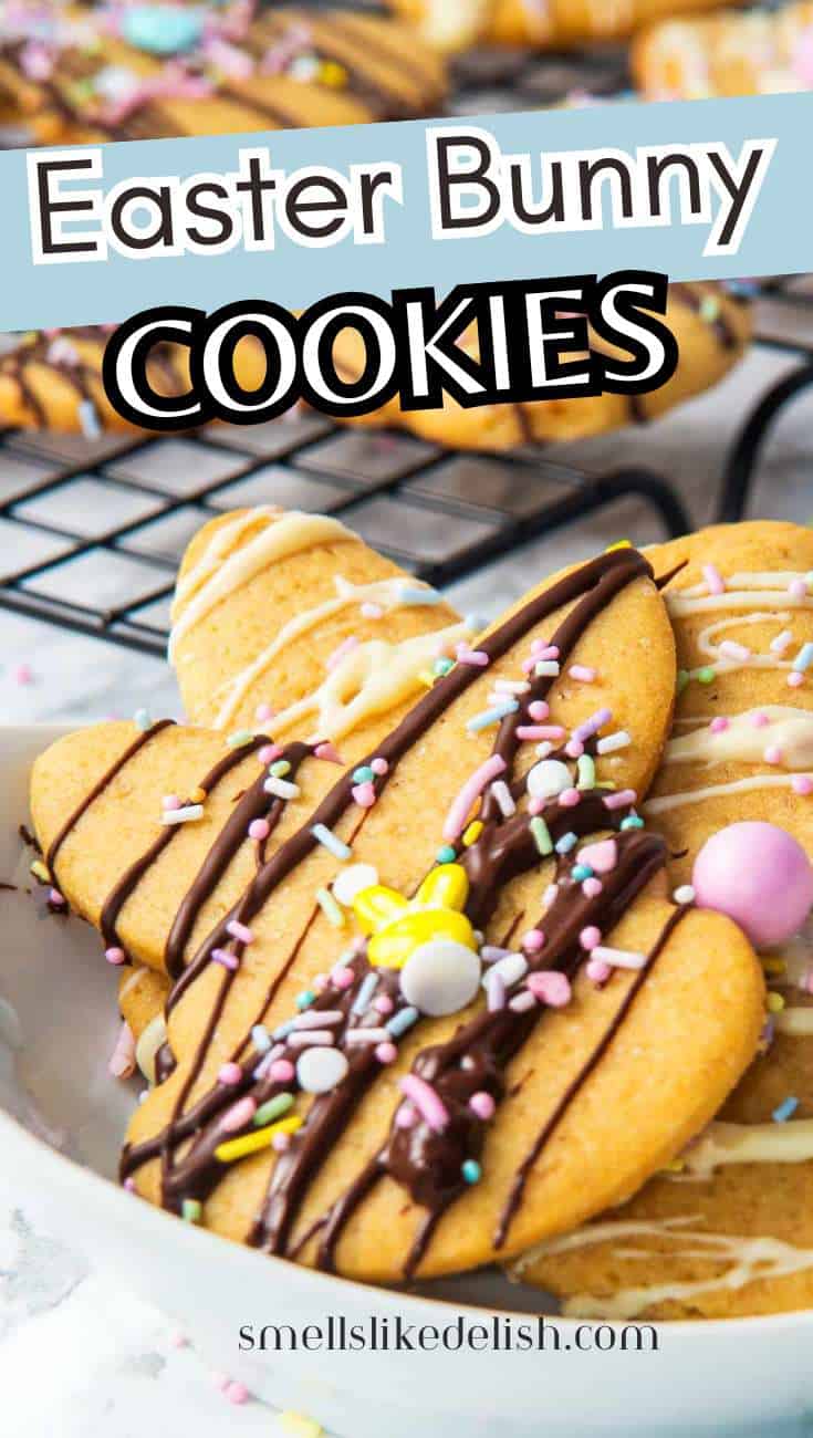 Easter bunny-shaped cookies with chocolate drizzle, sprinkles, and candy on a plate; more cookies cooling on a rack behind. Text: