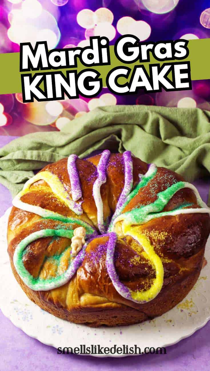 Round Mardi Gras king cake with purple, yellow, and green sugar on a white plate;