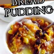 Bowl of rum raisin bread pudding with sauce beside a larger baking dish of pudding, text “Rum Raisin Bread Pudding,” and website “smellslikedelish.com” at the bottom.